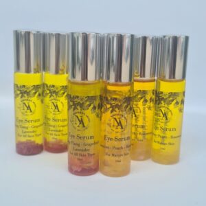 Lineup of Northern Aroma eye serums in 10ml glass roller bottles with silver caps. The oils range from pale yellow to golden amber, each infused with botanicals. Labels display blends such as Ylang Ylang–Grapefruit–Lavender and Jasmine–Peach–Rosewood. Set against a clean, soft background for a fresh, natural aesthetic.